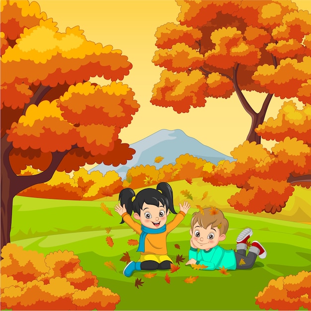 Niños felices de dibujos animados jugando en el fondo de otoño | Vector  Premium