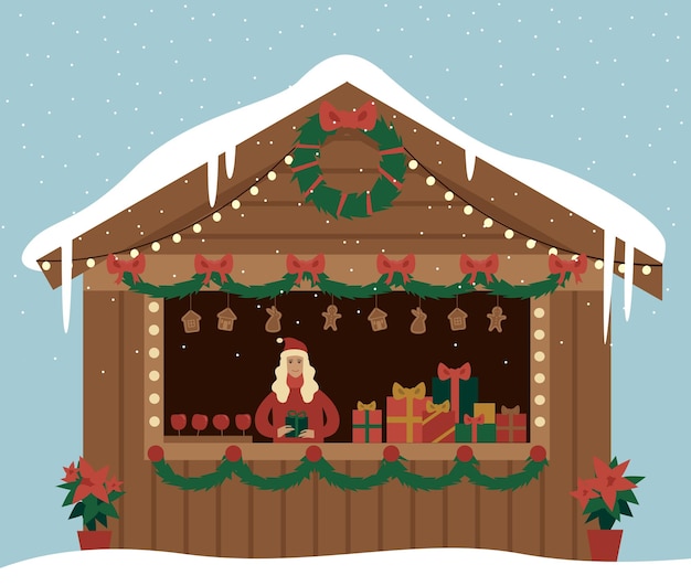 Pabellón del mercado de Navidad con cajas de regalos manzanas y panes de jengibre Stand del mercado callejero en la feria de Navidad