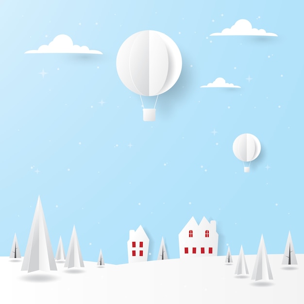 Paisaje de invierno, casas, pinos y globos aerostáticos volando en el cielo.