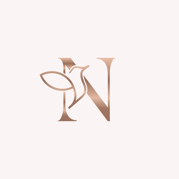 pájaro dorado logo belleza letra N