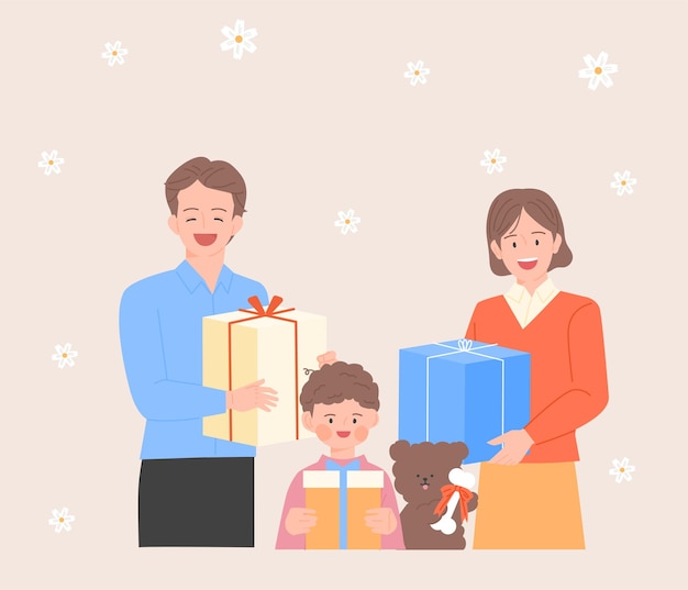 Papá, mamá y su hijo pequeño están parados con cajas de regalo.