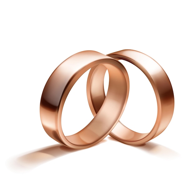 Un par de elegantes y brillantes anillos de bodas de oro rosa colocados uno al lado del otro para significar unidad y amor con una sombra suave sobre un fondo blanco