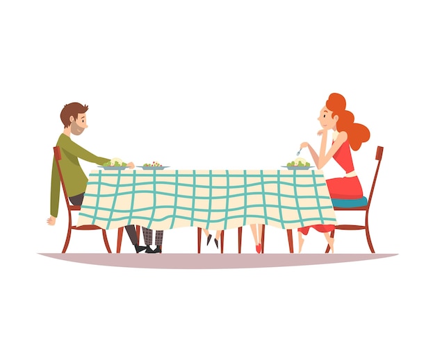 Una pareja familiar sentada en la mesa de la cocina con un mantel a cuadros y un hombre y una mujer comiendo juntos