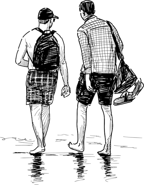 Personas caminando a la orilla del mar
