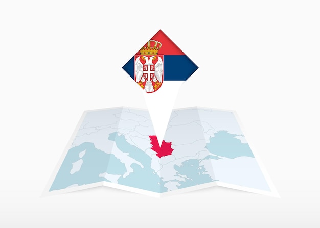 Serbia está representada en un mapa de papel plegado y un marcador de ubicación fijado con la bandera de Serbia