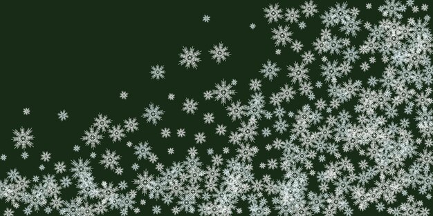 Subtiles copos de nieve y estrellas volando sobre el fondo verde de Navidad