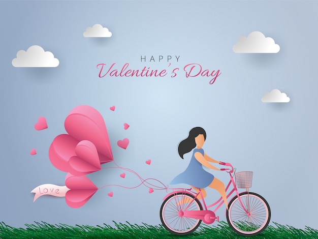 Tarjeta de feliz día de san valentín. mujer montando bicicleta con globos de aire de corazón sobre fondo de cielo azul