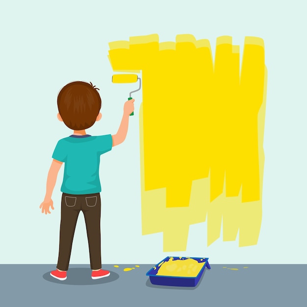 vista trasera de un lindo niño pintando en la pared de color amarillo con un rodillo de pintura