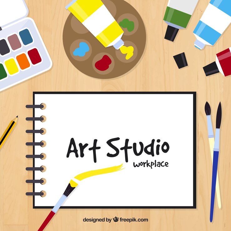 Vector Gratis desk with notebook and paintings