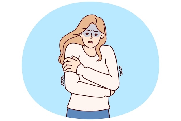Freezing woman hugging shoulders trying to keep warm and feeling chills after contracting flu