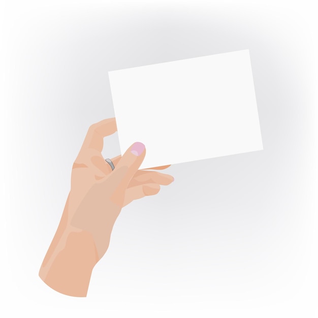 Hand with manicure and ring holding white blank card.