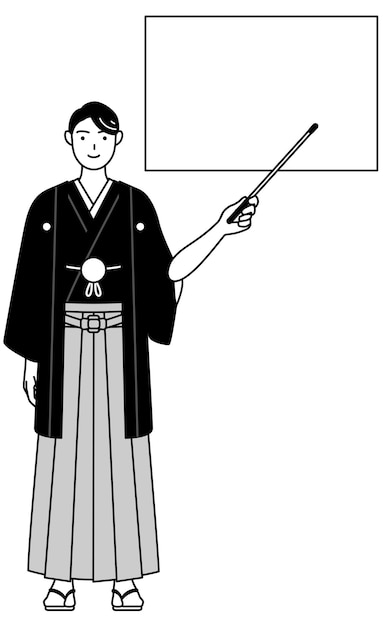 Man wearing Hakama with crest pointing at a whiteboard with an indicator stick