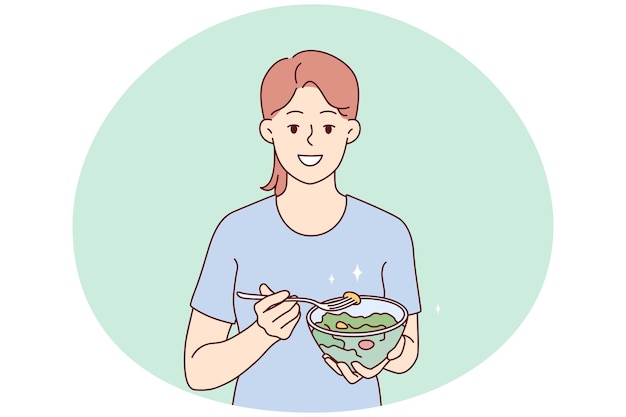 Smiling young woman eating healthy salad follow diet Happy girl enjoy vegetable meal care