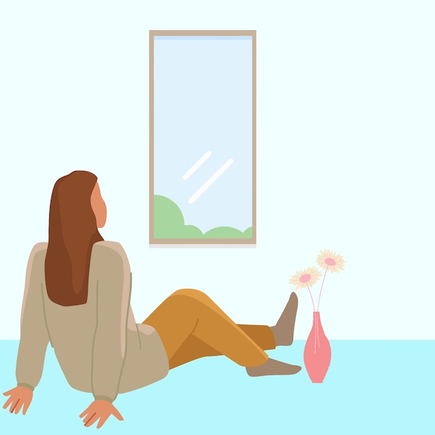 woman sitting on the floor near the window