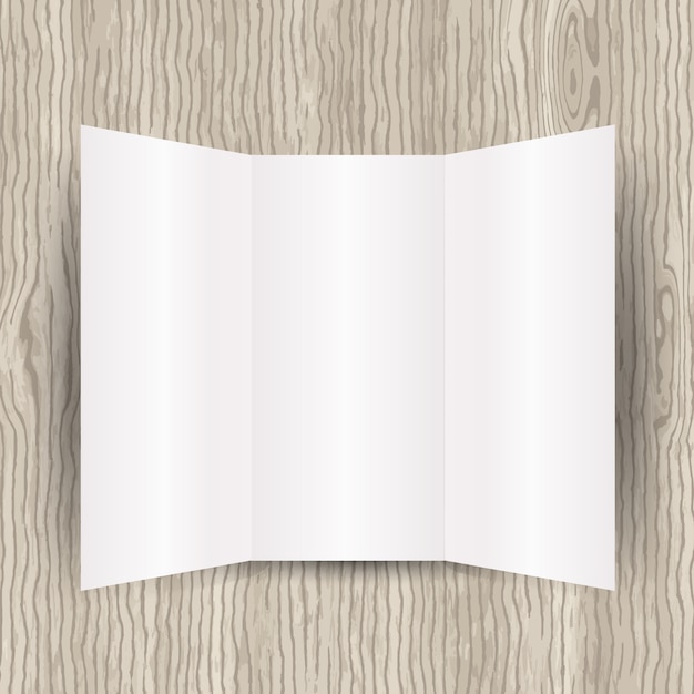 Blank tri-fach faltblatt auf einem hölzernen hintergrund