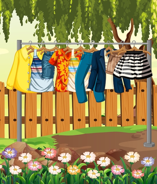 Kleidung, die an einer Wäscheleine mit Zaun und Blume in der Gartenszene hängt