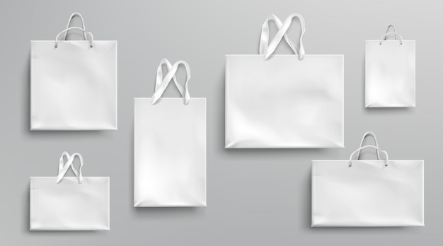Modell für einkaufstaschen aus papier, weiße pakete mit seil- und spitzengriffen, leere rechteckige ökologische geschenkverpackungen, isoliertes modell für branding und corporate identity design, realistisches 3d-set