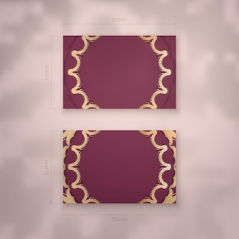 Visitenkarte in burgunder-farbe mit vintage-goldornamenten für ihre marke.