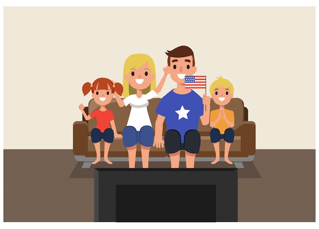 Amerikanische familie, die zu hause im guss von fernsehen zujubelt.