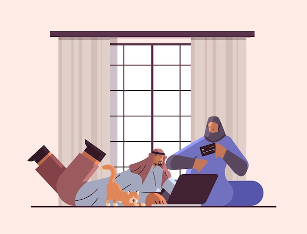 Arabisches paar mit kreditkarte mit laptop-online-shopping-konzept mann frau, die zusammen waren bestellt