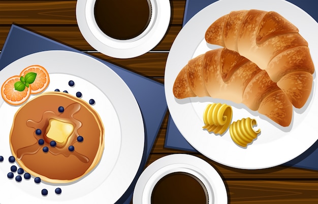 Vektor croissants und pfannkuchen auf dem tisch