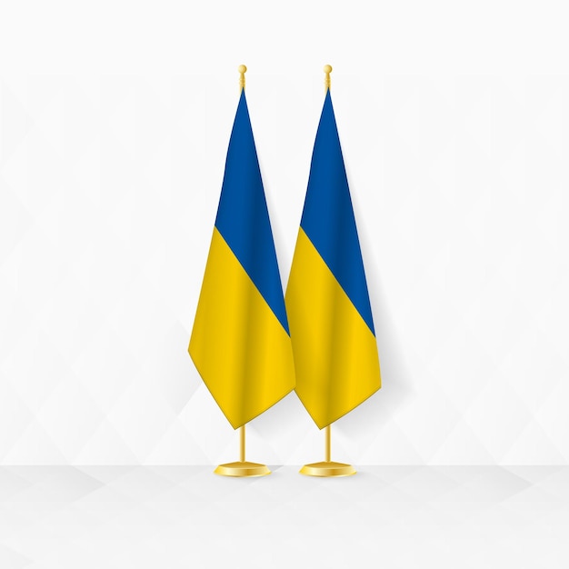 Die flaggen der ukraine und der ukraine auf dem flaggenstand dienen als illustration für diplomatie und andere treffen zwischen der ukraine und der ukraine