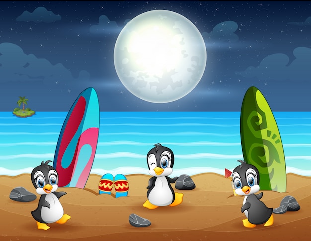 Drei pinguine spielen am strand