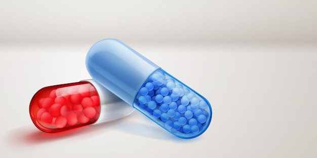Durchsichtige rote und blaue Kapseln mit weichen Schatten, die mit kleinen Arzneigranulaten im Inneren auf einer weißen Oberfläche gefüllt sind.