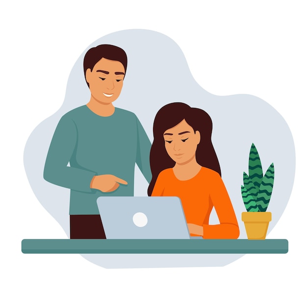 Ein Mädchen mit einem Laptop an einem Tisch, ein Mann neben ihr