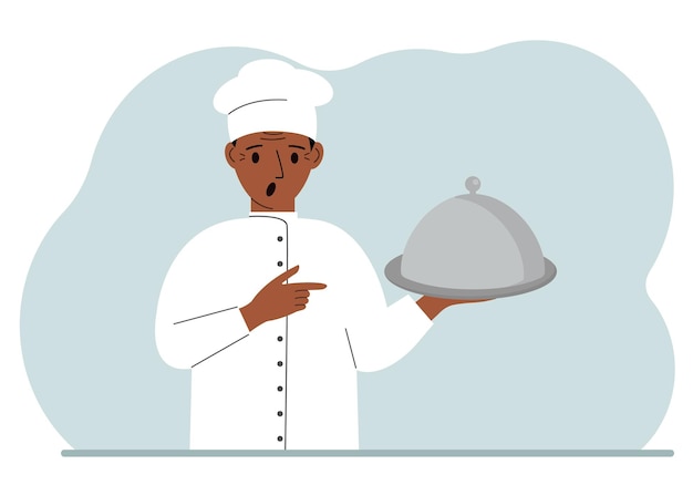 Ein männlicher Koch mit einem mit einer Glocke bedeckten Teller oder einem Tablett mit Deckel