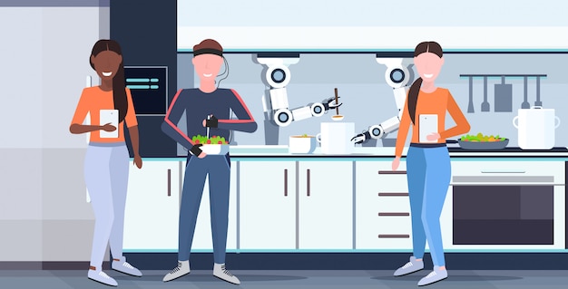Frauen, die mobile app verwenden, die mann humanoid mit drähten elektrodenindikatoren intelligenter handlicher kochroboter steuert, der lebensmittelroboterassistentkonzept modernes kücheninnenraum horizontal vorbereitet