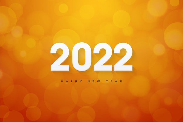 Frohes neues jahr 2022 mit zahlen auf einem orangefarbenen hintergrundunschärfe