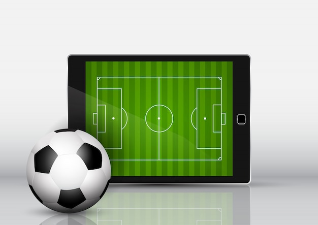 Fußball vor einem elektronischen gerät mit tonhöhe auf dem bildschirm
