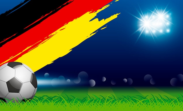 Fußballkugel auf gras- und malerpinseldeutschland-flagge