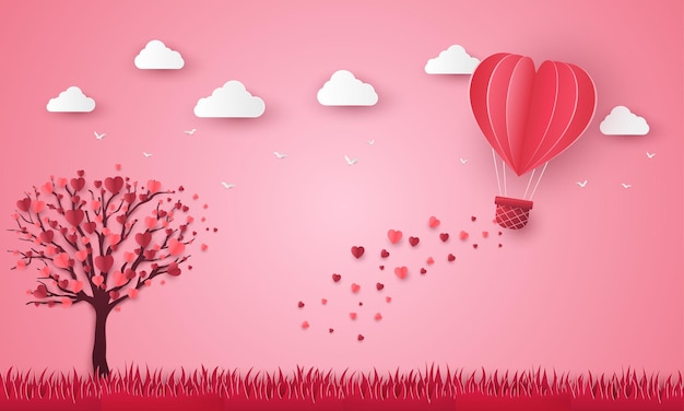 Herzballon, der über den Graspapierschnitt fliegt. Glücklicher Valentinstag Grußkartenbaum rosa Hintergrund.