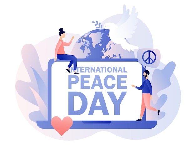 International peace day text auf dem laptop-bildschirm globe weiße taube und hippie-zeichen als frieden