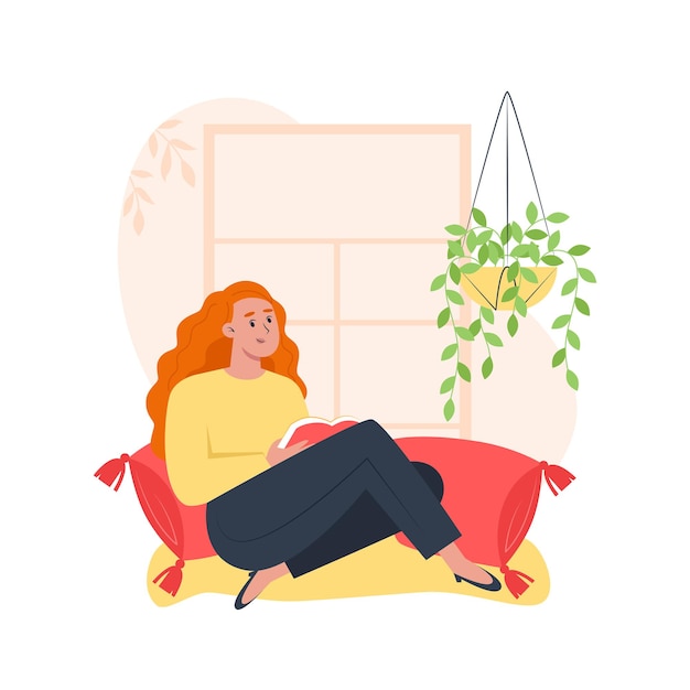 Junge Frau sitzt am Fenster und liest ein Buch, entspannt sich zu Hause
