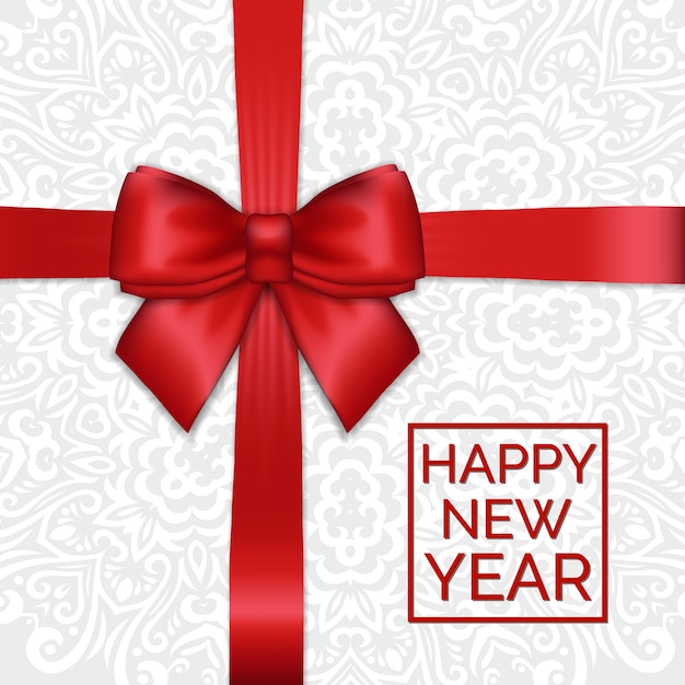 Roter satinbandbogen des glänzenden feiertags-neujahrs auf weißem spitzen-zierhintergrund.