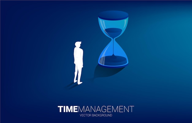 Silhouette eines Geschäftsmannes, der mit Sanduhr-Konzept für Büroangestellte und Arbeitszeit steht