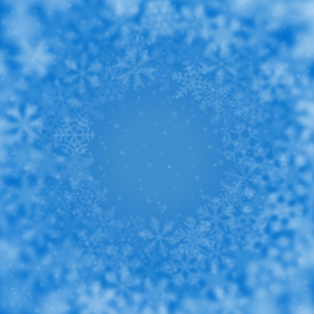 Weihnachtshintergrund von schneeflocken unterschiedlicher form, unschärfe und transparenz, in einem kreis angeordnet, auf hellblauem hintergrund