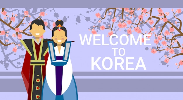 Willkommen in korea, koreanisches coupé in trachten über blühendem sakura-baum