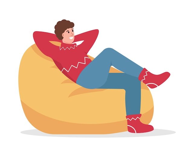 Happy man in warm clothes sitting in bean bag chair Cozy Winter at home in Snowy winter season
