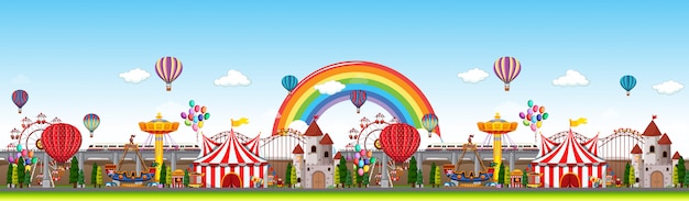 Cena de panorama de parque de diversões durante o dia com arco-íris no céu