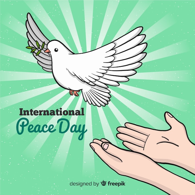 Fundo de dia de paz com pomba branca e mãos