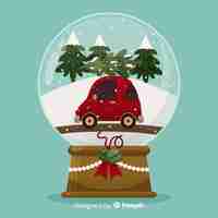 Vetor grátis globo de bola de neve de natal de design plano com carro