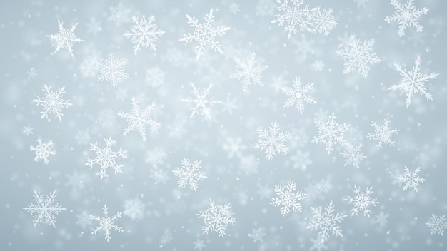 Plano de fundo de natal de complexos flocos de neve caindo nítidos e desfocados em cores azuis claras com efeito bokeh