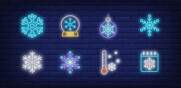 Vetor grátis símbolos de inverno definidos em estilo neon com flocos de neve