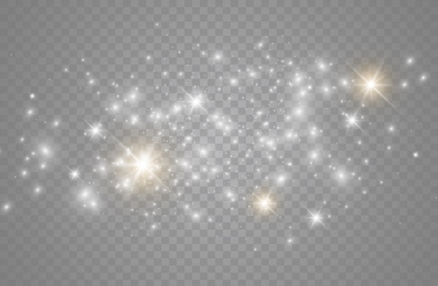 A poeira faisca e as estrelas douradas brilham com luz especial. brilha em um fundo transparente. Partículas de poeira mágica cintilante.