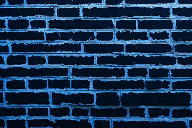A textura de uma parede de tijolos pintada de preto como fundo ou papel de parede