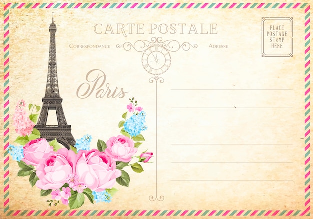 Antigo cartão postal em branco com selos de post e torre eiffel com flores da primavera na parte superior.